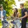 a group of people standing next to bicycles