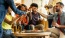 a group of people sitting around a table with beer bottles
