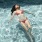 woman floats on her back in swimming pool